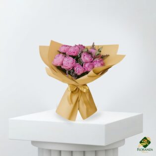 Pink peony bouquet wrapped in yellow paper